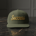 Success embroidered baseball cap in olive with gold embroidery