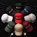 Success embroidered baseball cap flat lay showing multiple colorways on dark luxury background